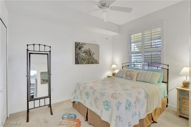 bedroom featuring light colored carpet, ceiling fan, and baseboards