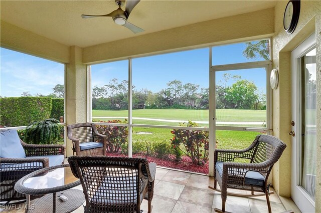 sunroom / solarium with plenty of natural light and ceiling fan