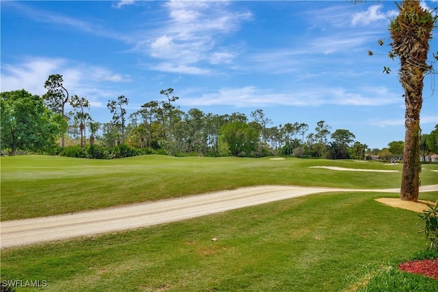 view of property's community featuring a yard and golf course view