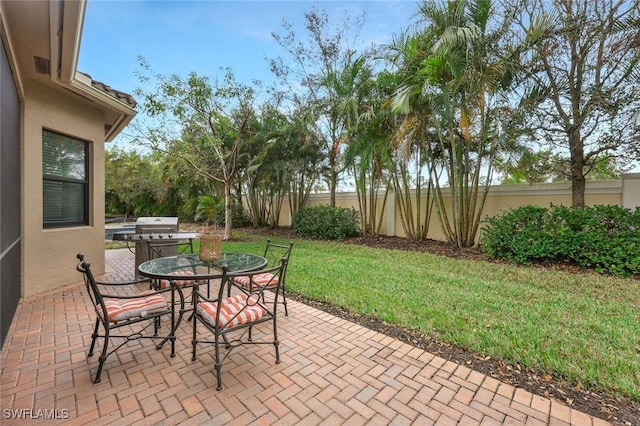 view of patio with fence and outdoor dining area