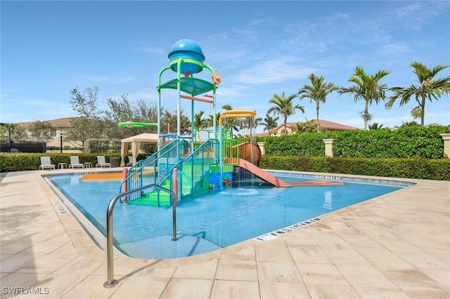 community playground featuring a community pool and a water play area