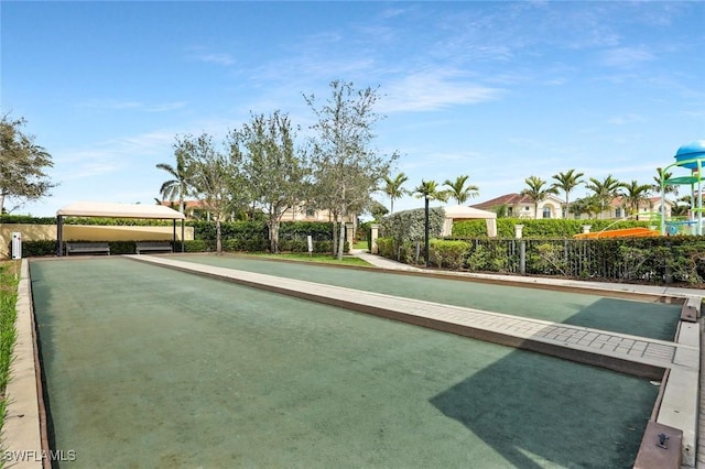 surrounding community with fence and a residential view