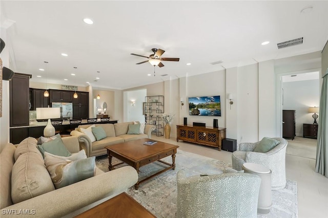 living area featuring a ceiling fan, recessed lighting, and visible vents