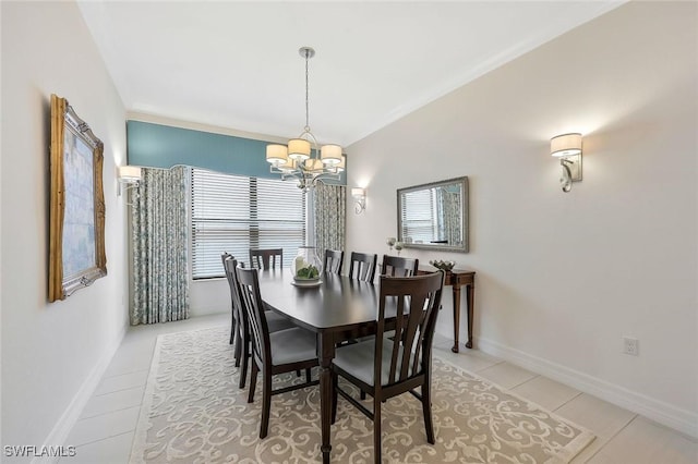 dining space with light tile patterned floors, baseboards, and an inviting chandelier