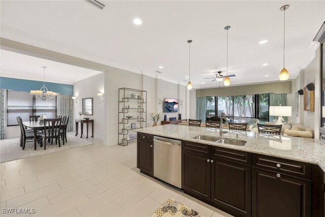 kitchen with pendant lighting, open floor plan, a sink, dishwasher, and ceiling fan with notable chandelier