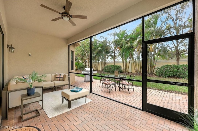 sunroom with a ceiling fan