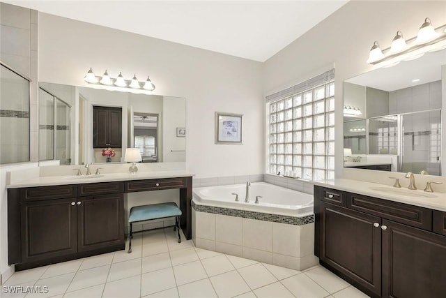 bathroom featuring a sink, a bath, and a shower stall