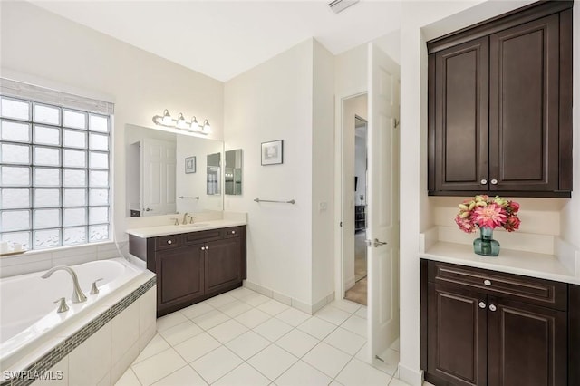 bathroom with visible vents, baseboards, tile patterned floors, vanity, and a bath