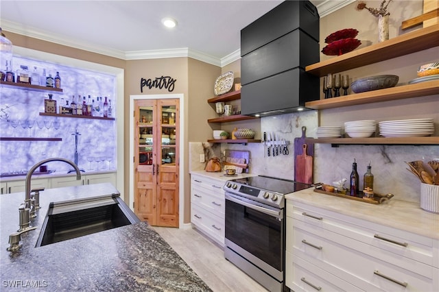 kitchen with electric range, ventilation hood, white cabinetry, open shelves, and a sink