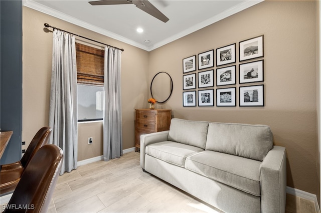 living area with ceiling fan, baseboards, and crown molding