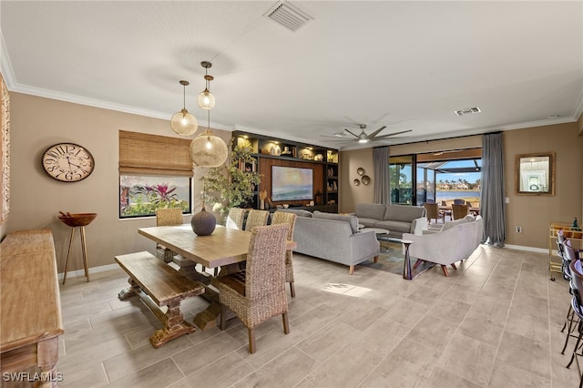 dining space with ceiling fan, baseboards, visible vents, and crown molding