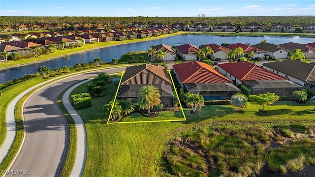 drone / aerial view featuring a residential view and a water view