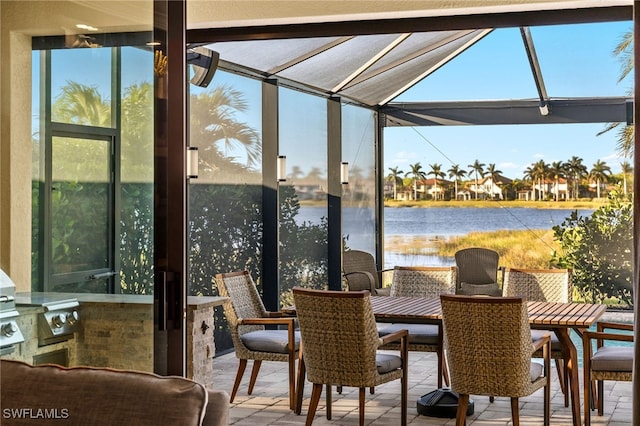 sunroom / solarium with a water view