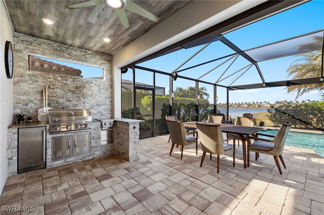 view of patio featuring an outdoor pool, an outdoor kitchen, area for grilling, a water view, and outdoor dining area