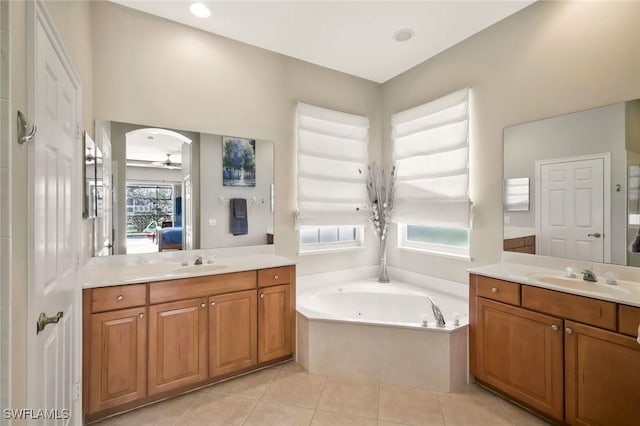 full bathroom featuring tile patterned flooring, two vanities, a sink, and ensuite bathroom