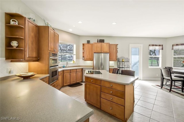 kitchen featuring light tile patterned floors, stainless steel appliances, open shelves, light countertops, and a kitchen island