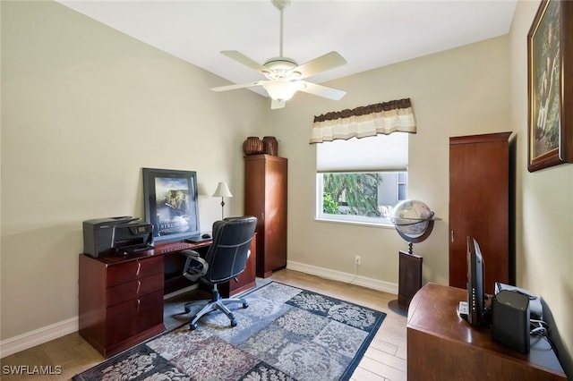 office area featuring wood finished floors, a ceiling fan, and baseboards