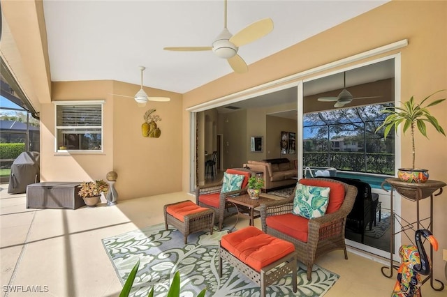 view of patio with glass enclosure, ceiling fan, and an outdoor hangout area