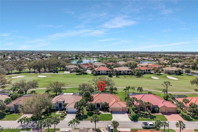 aerial view with golf course view and a residential view