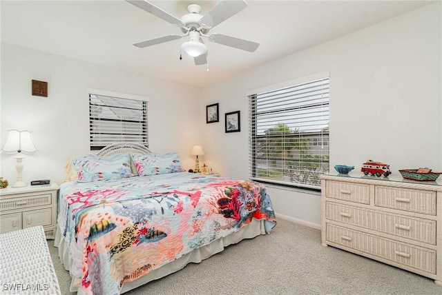 bedroom featuring baseboards, ceiling fan, and light colored carpet