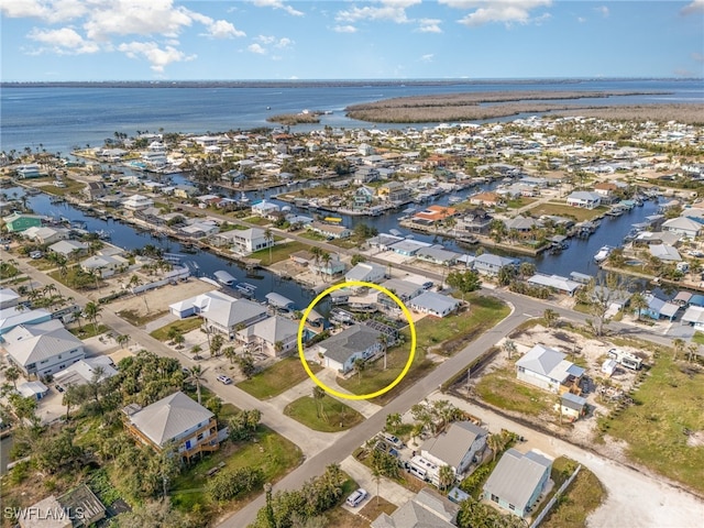 drone / aerial view with a residential view and a water view