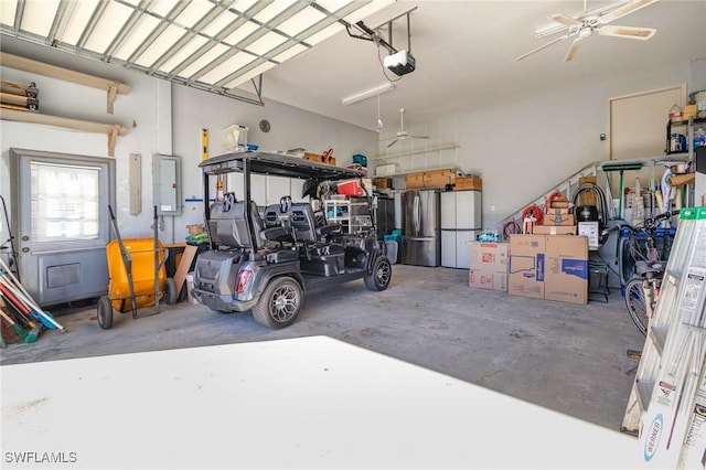 garage with freestanding refrigerator and a garage door opener