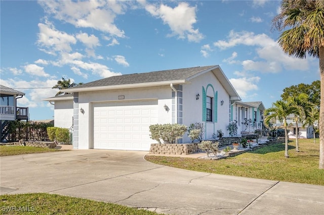 view of front of property featuring an attached garage, a front yard, concrete driveway, and stucco siding