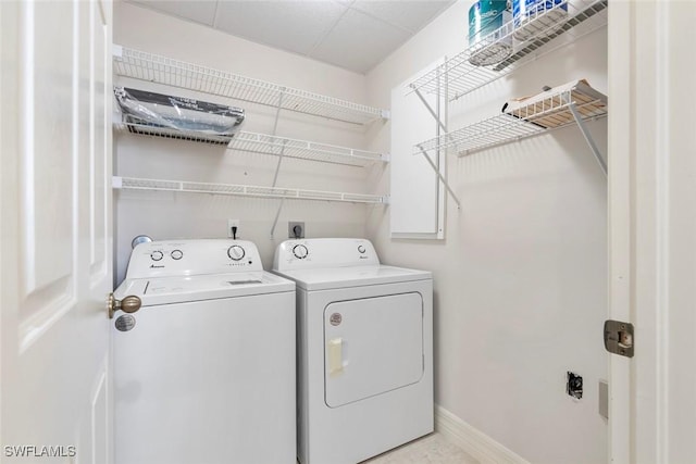 laundry area featuring laundry area, baseboards, and separate washer and dryer