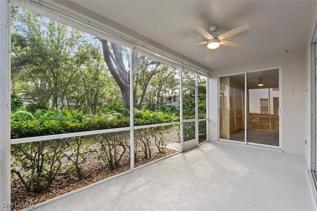 unfurnished sunroom featuring ceiling fan