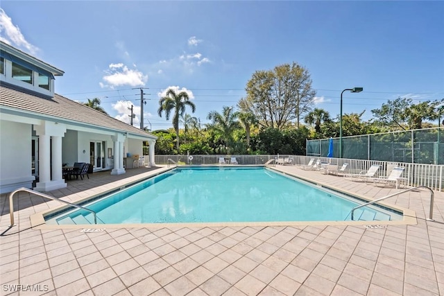 pool with fence and a patio