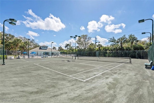 view of tennis court with fence