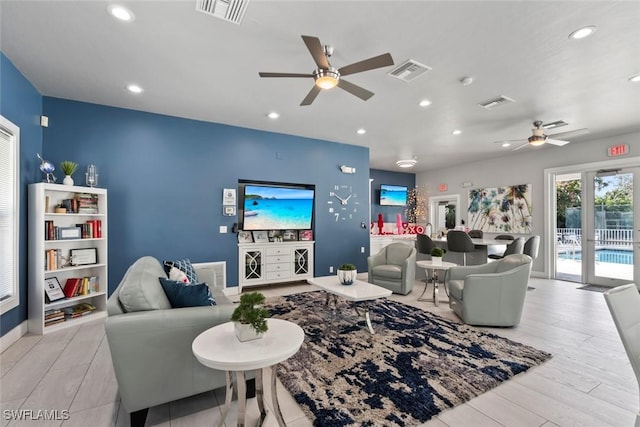 living area featuring light wood-style flooring, visible vents, and recessed lighting