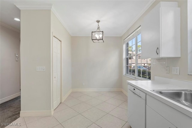 kitchen featuring light tile patterned floors, white dishwasher, baseboards, light countertops, and crown molding