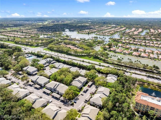 drone / aerial view featuring a water view and a residential view