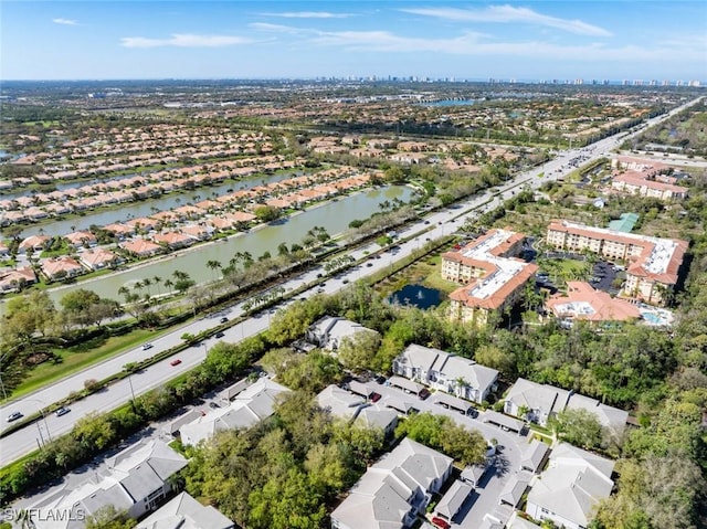 drone / aerial view with a water view and a residential view