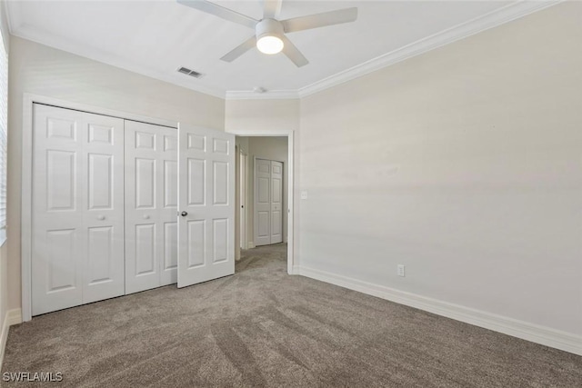 unfurnished bedroom with carpet floors, visible vents, ornamental molding, and baseboards