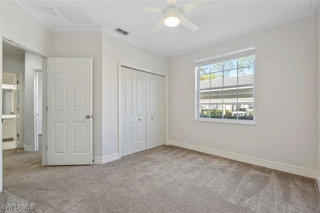 unfurnished bedroom with crown molding, visible vents, and carpet flooring