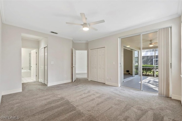 unfurnished bedroom featuring visible vents, baseboards, ornamental molding, access to exterior, and carpet