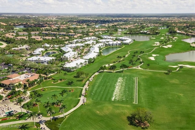 birds eye view of property featuring golf course view and a water view