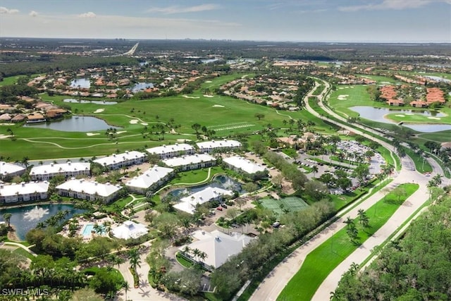 drone / aerial view featuring view of golf course and a water view