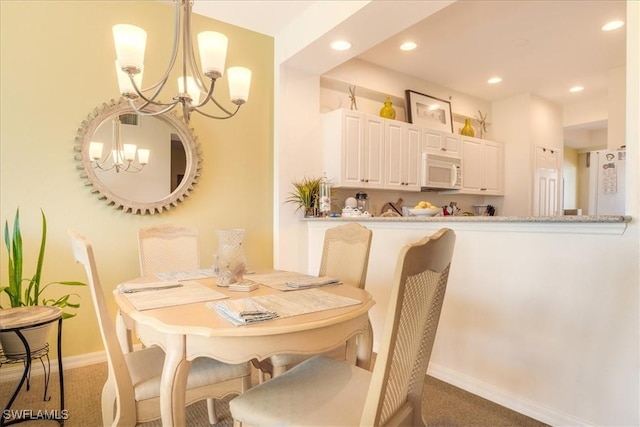 dining space featuring a chandelier, baseboards, carpet flooring, and recessed lighting