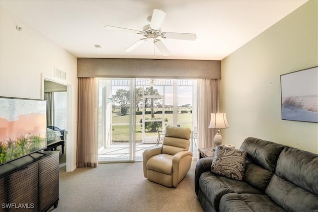 carpeted living room with visible vents and ceiling fan