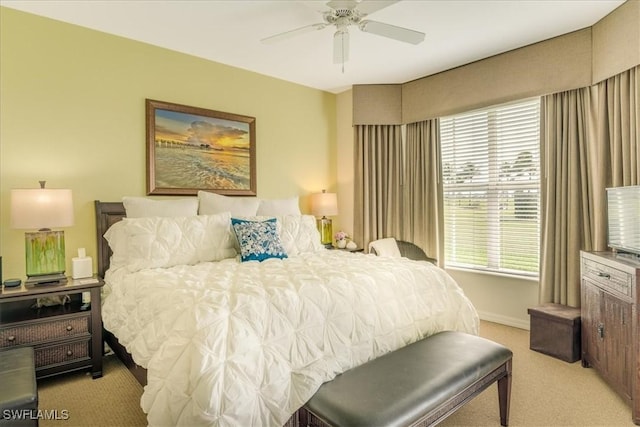 bedroom with light carpet, ceiling fan, and baseboards