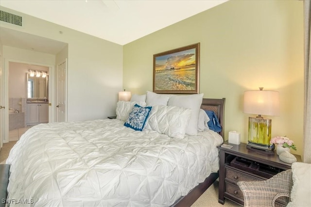 bedroom featuring ensuite bath and visible vents