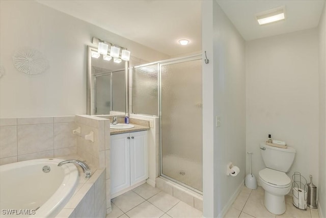 bathroom featuring a garden tub, a shower stall, vanity, and tile patterned floors