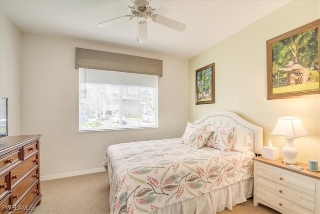 bedroom with baseboards, a ceiling fan, and light colored carpet