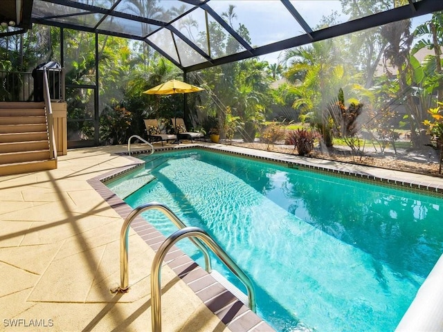 pool with glass enclosure and a patio