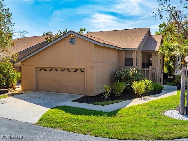 ranch-style house featuring an attached garage, a shingled roof, a front lawn, and concrete driveway