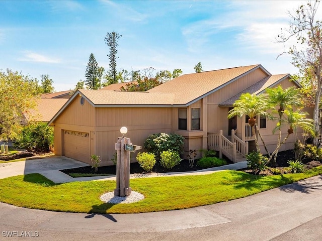 view of front of house featuring a front yard, driveway, and an attached garage