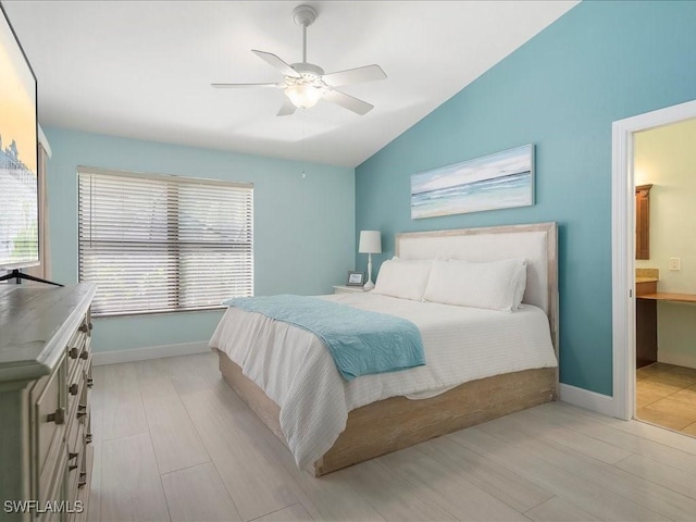 bedroom featuring lofted ceiling, a ceiling fan, and baseboards